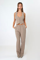 April Seven cropped backless vest and straight-leg pant set in mocha – neutral tailored two-piece with cropped vest and mid-waist trousers.