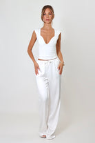 April Seven Beverly Top in white – minimalist fitted top with plunging neckline, cap sleeves, and sculpted silhouette.
