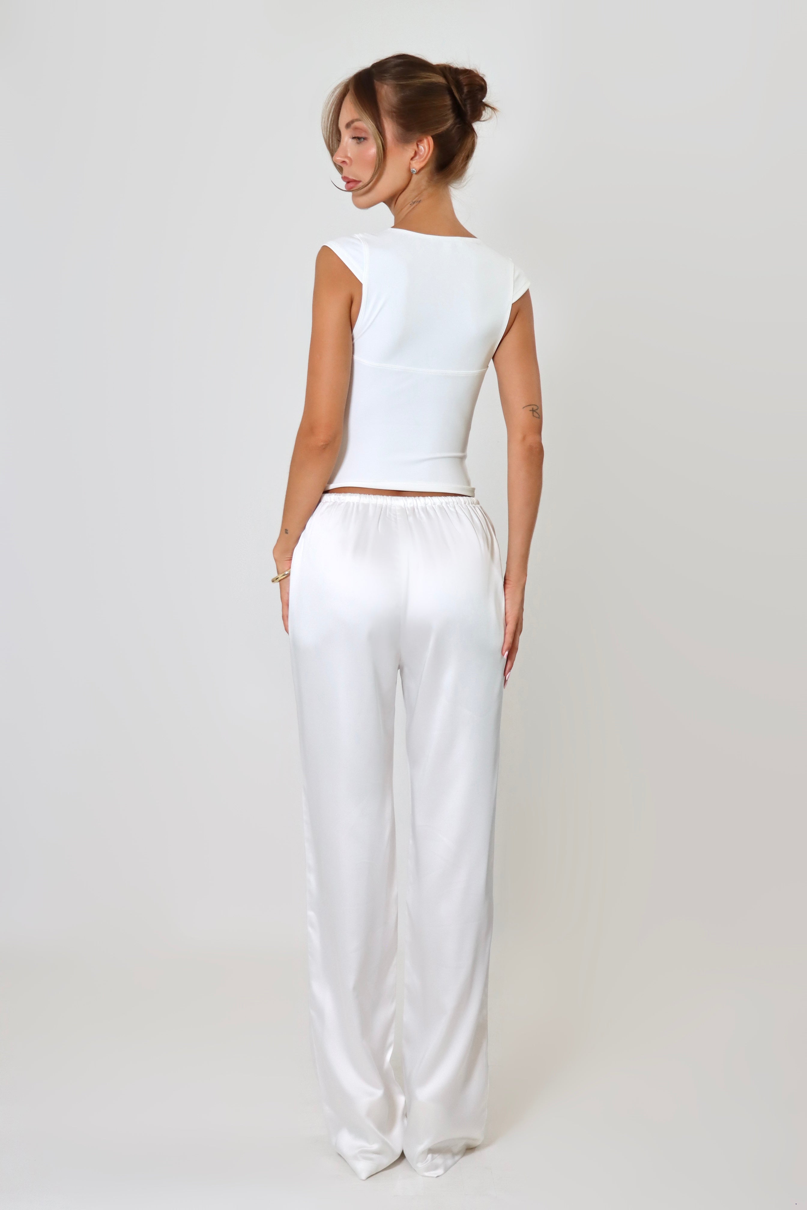 April Seven Beverly Top in white – minimalist fitted top with plunging neckline, cap sleeves, and sculpted silhouette.